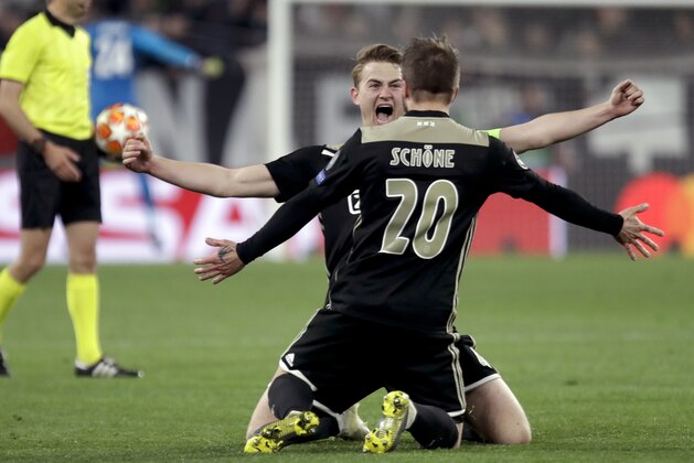 Ajax's Matthijs de Ligt and Lasse Schone celebrate at the end of the Champions League, quarterfinal, second leg soccer match between Juventus and Ajax, at the Allianz stadium in Turin, Italy, Tuesday, April 16, 2019. Ajax won 2-1 and advances to the semifinal on a 3-2 aggregate. (AP Photo/Luca Bruno)