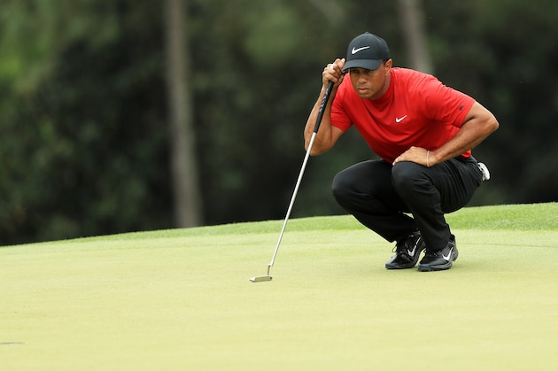 AUGUSTA, GEORGIA - APRIL 14: Tiger Woods of the United States lines up a putt on the 18th green during the final round of the Masters at Augusta National Golf Club on April 14, 2019 in Augusta, Georgia. (Photo by Mike Ehrmann/Getty Images)