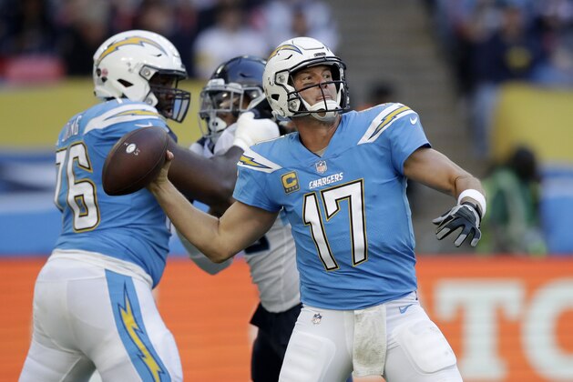 FILE - In this  Sunday, Oct. 21, 2018 file photo,Los Angeles Chargers quarterback Philip Rivers (17) passes the ball during the first half of an NFL football game against Tennessee Titans at Wembley stadium in London. Try as he might, Von Miller just can't find anything bad to say about Philip Rivers anymore.