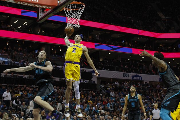 Los Angeles Lakers guard Lonzo Ball (2) dunks against Charlotte Hornets center Cody Zeller, left, in the second half of an NBA basketball game in Charlotte, N.C., Saturday, Dec. 15, 2018. (AP Photo/Nell Redmond)