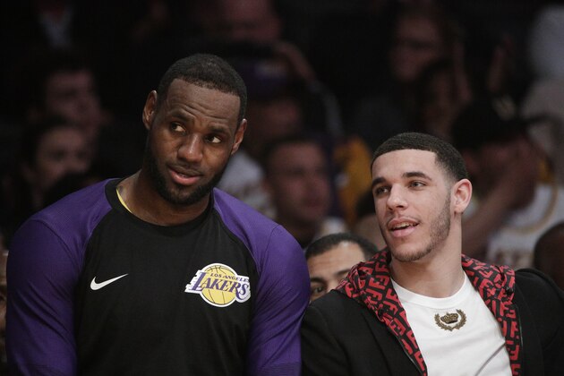 Los Angeles Lakers' LeBron James, left, and Lonzo Ball sit on the bench during the second half of an NBA basketball game against the Washington Wizards, Tuesday, March 26, 2019, in Los Angeles. (AP Photo/Jae C. Hong)