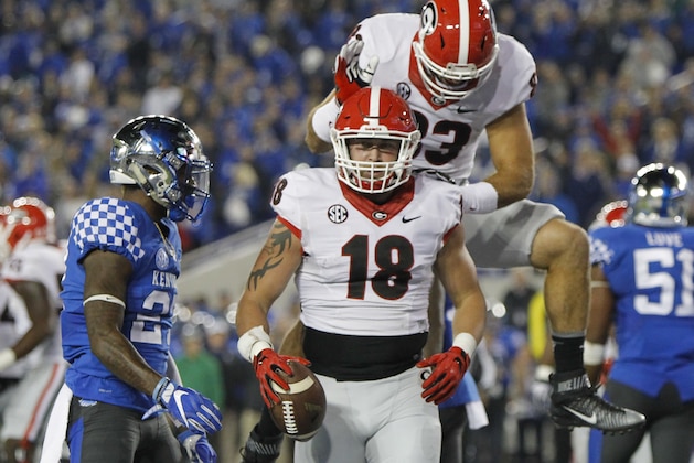 Georgia tight end Jeb Blazevich jumps onto tight end Isaac Nauta after Nauta caught a pass in the end zone for a 2-point conversion against Kentucky during the second half of an NCAA college football game Saturday, Nov. 5, 2016, in Lexington, Ky. Georgia won 27-24. (AP Photo/David Stephenson)