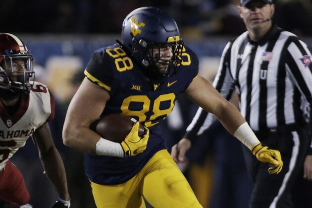 Oklahoma cornerback Tre Brown (6) attempts to tackle West Virginia tight end Trevon Wesco (88) during the first half of an NCAA college football game Friday, Nov. 23, 2018, in Morgantown, W.Va. (AP Photo/Raymond Thompson)
