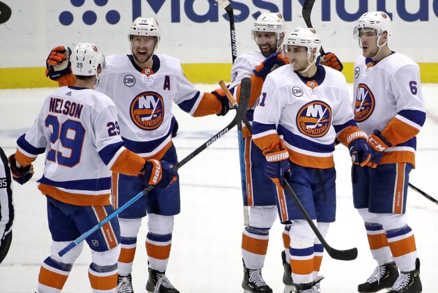 New York Islanders' Josh Bailey (12) celebrates his empty-net goal against the Pittsburgh Penguins during the third period in Game 4 of an NHL hockey first-round playoff series in Pittsburgh, Tuesday, April 16, 2019. The Islanders won 3-1, sweeping the series. (AP Photo/Gene J. Puskar)