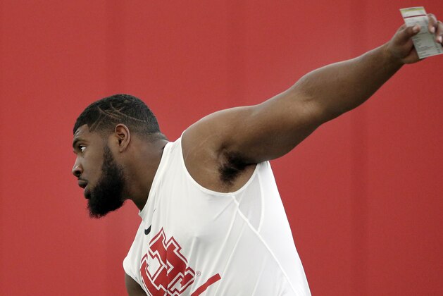 Houston defensive lineman Ed Oliver Jr. stretches as he participates in drills during Pro Day at the indoor football practice facility at the University of Houston Thursday, March, 28, 2019, in Houston. (AP Photo/Michael Wyke)