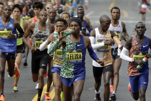 Lelisa Desisa, of Ethiopia, leads the pack of men's elite runners along the course during the the 123rd Boston Marathon on Monday, April 15, 2019, . (AP Photo/Steven Senne)