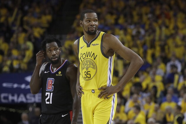 Golden State Warriors forward Kevin Durant (35) stands next to Los Angeles Clippers guard Patrick Beverley (21) during the second half of Game 2 of a first-round NBA basketball playoff series in Oakland, Calif., Monday, April 15, 2019. (AP Photo/Jeff Chiu)