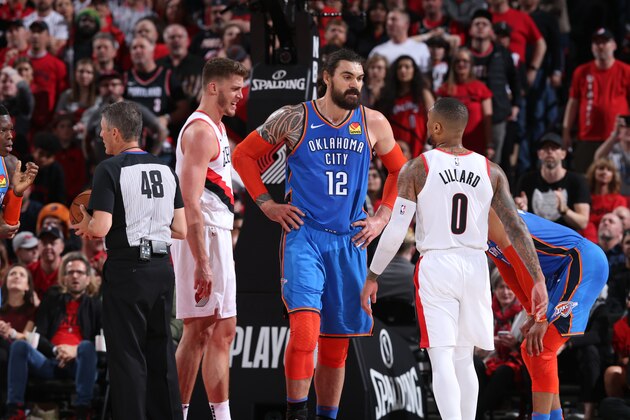 PORTLAND, OR - APRIL 16: Steven Adams #12 of the Oklahoma City Thunder talks with Damian Lillard #0 of the Portland Trail Blazers during Game Two of Round One of the 2019 NBA Playoffs on April 16, 2019 at the Moda Center in Portland, Oregon. NOTE TO USER: User expressly acknowledges and agrees that, by downloading and or using this Photograph, user is consenting to the terms and conditions of the Getty Images License Agreement. Mandatory Copyright Notice: Copyright 2019 NBAE (Photo by Sam Forencich/NBAE via Getty Images)