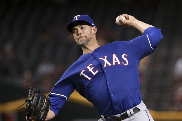 Texas Rangers starting pitcher Mike Minor throws to an Arizona Diamondbacks batter during the first inning of a baseball game Tuesday, April 9, 2019, in Phoenix. (AP Photo/Ross D. Franklin)