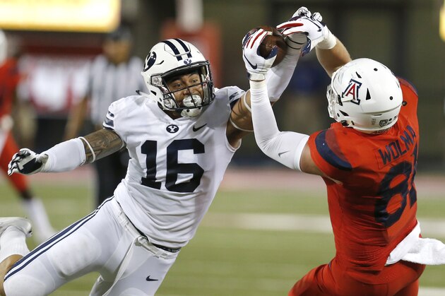 BYU  linebacker Sione Takitaki (16) breaks up a pass intended for Arizona tight end Bryce Wolma (81) during the first half of an NCAA college football game Saturday, Sept. 1, 2018, in Tucson, Ariz. (AP Photo/Rick Scuteri)