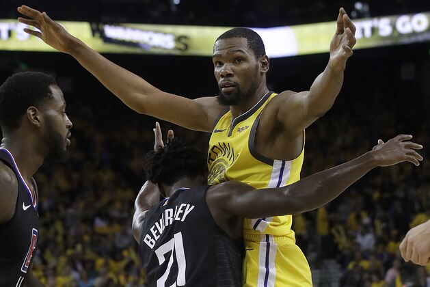 Golden State Warriors forward Kevin Durant, top, is defended by Los Angeles Clippers guard Patrick Beverley (21) during the second half of Game 2 of a first-round NBA basketball playoff series in Oakland, Calif., Monday, April 15, 2019. (AP Photo/Jeff Chiu)