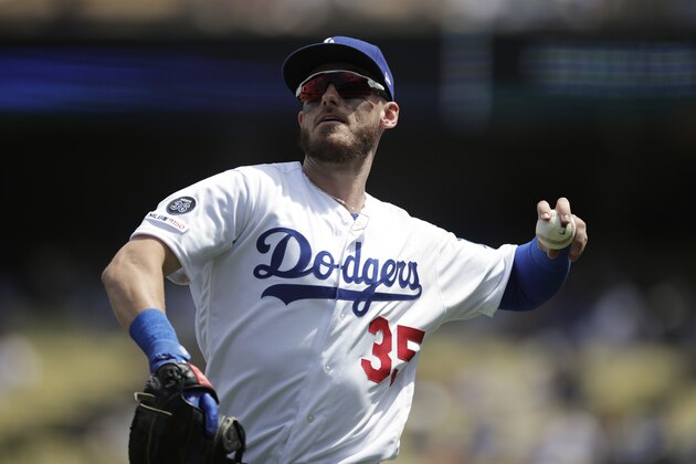 Los Angeles Dodgers' Cody Bellinger throws the ball as he walks off the field after the first inning of a baseball game against the Milwaukee Brewers, Sunday, April 14, 2019, in Los Angeles. (AP Photo/Jae C. Hong)
