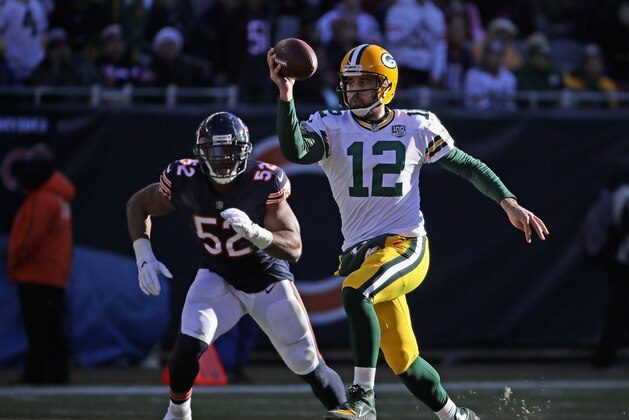 CHICAGO, IL - DECEMBER 16:  Aaron Rodgers #12 of the Green Bay Packers tries to throw while being chased by Khalil Mack #52 of the Chicago Bears at Soldier Field on December 16, 2018 in Chicago, Illinois.  (Photo by Jonathan Daniel/Getty Images)