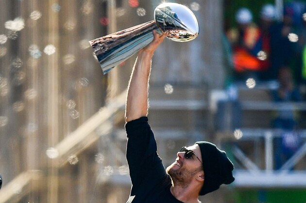BOSTON, MASSACHUSETTS - FEBRUARY 05: Tom Brady #12 of the New England Patriots reacts as he holds the Vince Lombardi trophy during the Super Bowl Victory Parade on February 05, 2019 in Boston, Massachusetts. (Photo by Billie Weiss/Getty Images)