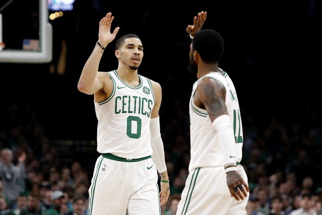 Boston Celtics' Jayson Tatum high fives with Kyrie Irving during the second quarter of an NBA basketball game against the Indiana Pacers Friday, March 29, 2019, in Boston. (AP Photo/Winslow Townson)