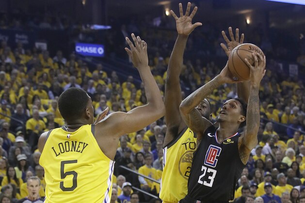 Los Angeles Clippers guard Lou Williams (23) shoots against Golden State Warriors center Kevon Looney (5) and forward Draymond Green during the first half of Game 2 of a first-round NBA basketball playoff series in Oakland, Calif., Monday, April 15, 2019. (AP Photo/Jeff Chiu)