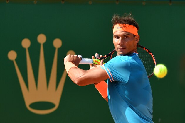Spain's Rafael Nadal returns a ball to Bulgaria's Grigor Dimitrov during their tennis match on the day 6 of the Monte-Carlo ATP Masters Series tournament in Monaco on April 18, 2019. (Photo by YANN COATSALIOU / AFP)        (Photo credit should read YANN COATSALIOU/AFP/Getty Images)
