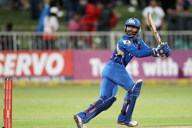 Dinesh Karthik of the Mumbai Indians eyes the ball on October 22, 2012 during a Champions League T20 (CLT20) match Sydney Sixers vs Mumbai Indians at Sahara Stadium Kingsmead in Durban. AFP PHOTO / STR        (Photo credit should read -/AFP/Getty Images)