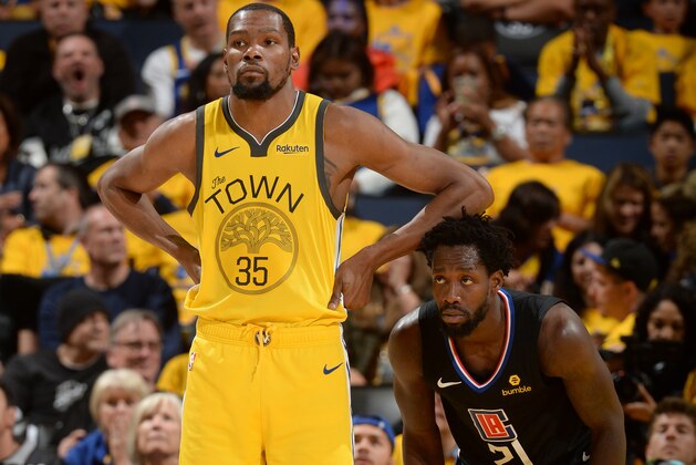 OAKLAND, CA - APRIL 15: Kevin Durant #35 of the Golden State Warriors looks on against Patrick Beverley #21 of the LA Clippers during Game Two of Round One of the 2019 NBA Playoffs on April 15, 2019 at ORACLE Arena in Oakland, California. NOTE TO USER: User expressly acknowledges and agrees that, by downloading and or using this photograph, user is consenting to the terms and conditions of Getty Images License Agreement. Mandatory Copyright Notice: Copyright 2019 NBAE (Photo by Noah Graham/NBAE via Getty Images)