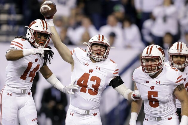 Wisconsin's Ryan Connelly (43] celebrates along side teammates D'Cota Dixon (14) Garret Dooley after running back a Penn State fumble for a touchdown during the first half of the Big Ten championship NCAA college football game Saturday, Dec. 3, 2016, in Indianapolis. (AP Photo/Michael Conroy)
