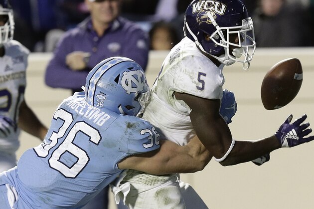 North Carolina's Cole Holcomb (36) hits Western Carolina's Connell Young (5) to cause a fumble during the second half of an NCAA college football game in Chapel Hill, N.C., Saturday, Nov. 17, 2018. North Carolina won 49-26. (AP Photo/Gerry Broome)