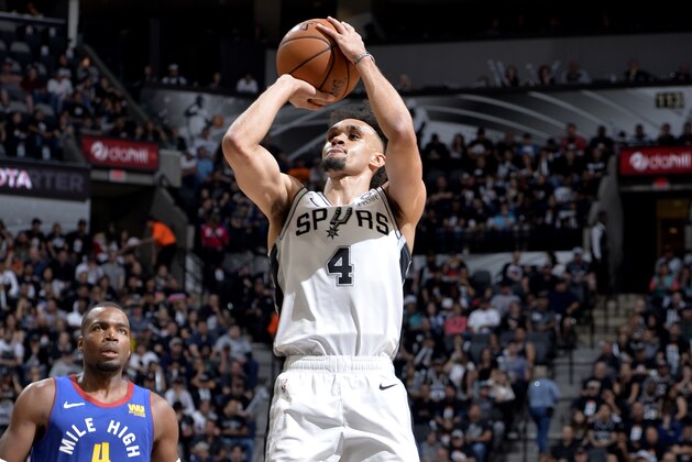 SAN ANTONIO, TX - APRIL 18: Derrick White #4 of the San Antonio Spurs shoots the ball against the Denver Nuggets  during Game Three of Round One of the 2019 NBA Playoffs on April 18, 2019 at the AT&T Center in San Antonio, Texas. NOTE TO USER: User expressly acknowledges and agrees that, by downloading and or using this photograph, user is consenting to the terms and conditions of the Getty Images License Agreement. Mandatory Copyright Notice: Copyright 2019 NBAE (Photos by Mark Sobhani/NBAE via Getty Images)