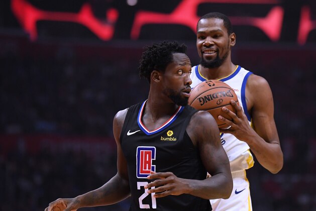 LOS ANGELES, CALIFORNIA - APRIL 18:  Patrick Beverley #21 of the LA Clippers looks back at a smiling Kevin Durant #35 of the Golden State Warriors during Game Two of Round One of the 2019 NBA Playoffs at Staples Center on April 18, 2019 in Los Angeles, California. (Photo by Harry How/Getty Images)  NOTE TO USER: User expressly acknowledges and agrees that, by downloading and or using this photograph, User is consenting to the terms and conditions of the Getty Images License Agreement.