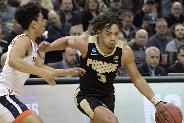 Purdue's Carsen Edwards (3) dribbles past Virginia's Kihei Clark (0) during the first half of the men's NCAA Tournament college basketball South Regional final game, Saturday, March 30, 2019, in Louisville, Ky. (AP Photo/Timothy D. Easley)