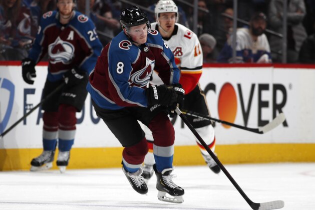Colorado Avalanche defenseman Cale Makar, front, loses control of a pass as Calgary Flames center Mikael Backlund defends in the second period of Game 4 of an NHL hockey playoff series Wednesday, April 17, 2019, in Denver. (AP Photo/David Zalubowski)