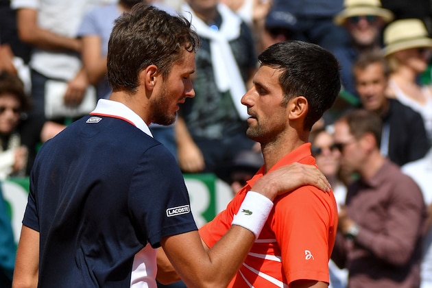 Serbia's Novak Djokovic (2R, UP) and Russia's Daniil Medvedev talk to each other at the end of the quarter final tennis match on the day 7 of the Monte-Carlo ATP Masters Series tournament on April 19, 2019 in Monaco. (Photo by YANN COATSALIOU / AFP)        (Photo credit should read YANN COATSALIOU/AFP/Getty Images)