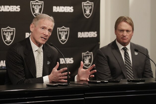 FILE - In this Monday, Dec. 31, 2018, file photo, Mike Mayock, left, speaks as Oakland Raiders head coach Jon Gruden listens at a news conference announcing Mayock as the general manager at the team's headquarters in Oakland, Calif. Mayock knows he will be highly scrutinized with three first-round picks thanks to Gruden's much-criticized trades. (AP Photo/Jeff Chiu, File)