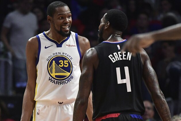 Golden State Warriors forward Kevin Durant, left, and Los Angeles Clippers forward JaMychal Green jaw at each other during the second half in Game 3 of a first-round NBA basketball playoff series Thursday, April 18, 2019, in Los Angeles. The Warriors won 132-105. (AP Photo/Mark J. Terrill)