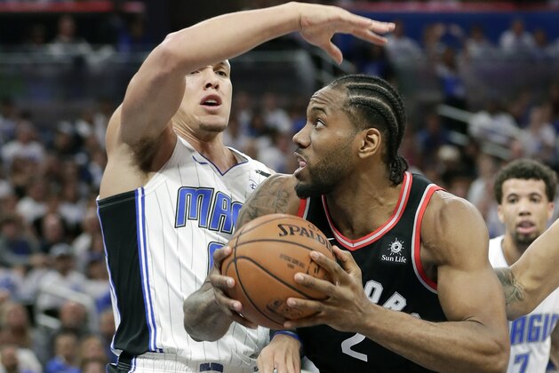 Toronto Raptors' Kawhi Leonard, right, looks looks for a shot as he is defended by Orlando Magic's Aaron Gordon during the first half in Game 3 of a first-round NBA basketball playoff series, Friday, April 19, 2019, in Orlando, Fla. (AP Photo/John Raoux)