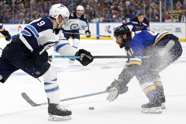 Winnipeg Jets center Andrew Copp (9) and St. Louis Blues defenseman Robert Bortuzzo (41) battle for the puck during the third period in Game 4 of an NHL first-round hockey playoff series Tuesday, April 16, 2019, in St. Louis. (AP Photo/Jeff Roberson)