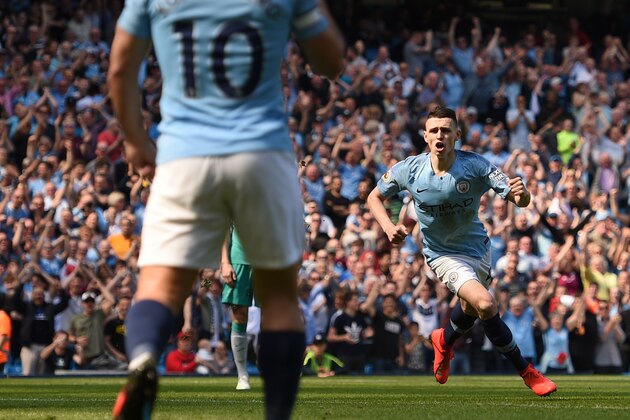 Manchester City's English midfielder Phil Foden (R) celebrates scoring the opening goal during the English Premier League football match between Manchester City and Tottenham Hotspur at the Etihad Stadium in Manchester, north west England, on April 20, 2019. (Photo by Oli SCARFF / AFP) / RESTRICTED TO EDITORIAL USE. No use with unauthorized audio, video, data, fixture lists, club/league logos or 'live' services. Online in-match use limited to 120 images. An additional 40 images may be used in extra time. No video emulation. Social media in-match use limited to 120 images. An additional 40 images may be used in extra time. No use in betting publications, games or single club/league/player publications. /         (Photo credit should read OLI SCARFF/AFP/Getty Images)