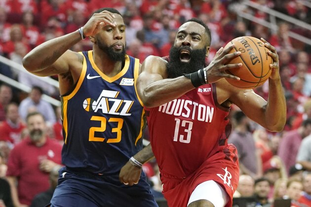 Houston Rockets guard James Harden (13) drives against Utah Jazz forward Royce O'Neale (23) during the first half of Game 2 of a first-round NBA basketball playoff series in Houston, Wednesday, April 17, 2019. (AP Photo/David J. Phillip)