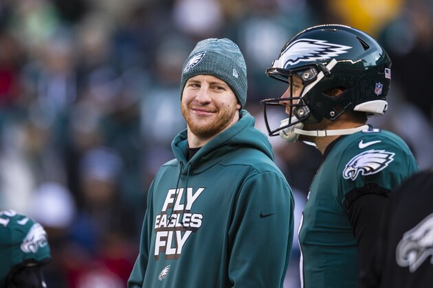 PHILADELPHIA, PA - DECEMBER 23:  Carson Wentz #11 speaks with Nick Foles #9 of the Philadelphia Eagles before the game against the Houston Texans at Lincoln Financial Field on December 23, 2018 in Philadelphia, Pennsylvania. Philadelphia defeats Houston 32-30.  (Photo by Brett Carlsen/Getty Images)