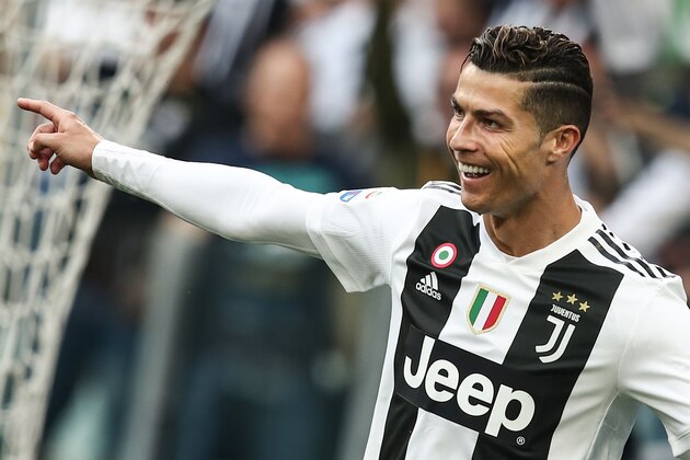 Juventus' Portuguese forward Cristiano Ronaldo celebrates after Fiorentina scored an own goal following Ronaldo's shot during the Italian Serie A football match Juventus vs Fiorentina on April 20, 2019 at the Juventus stadium in Turin. (Photo by Isabella BONOTTO / AFP)        (Photo credit should read ISABELLA BONOTTO/AFP/Getty Images)