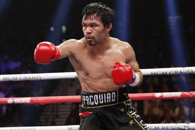 Manny Pacquiao fights Adrien Broner, not pictured, in a welterweight championship boxing match Saturday, Jan. 19, 2019, in Las Vegas. (AP Photo/John Locher)