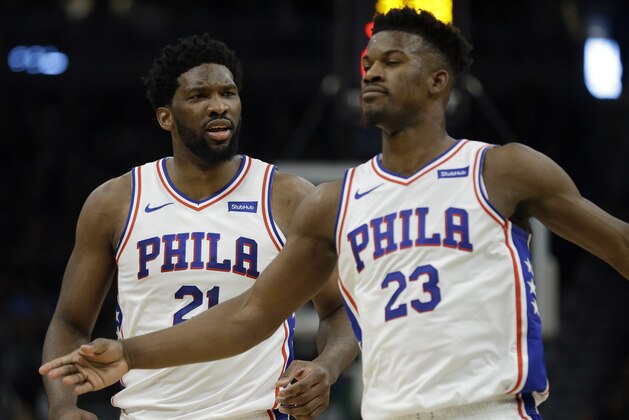 Philadelphia 76ers' Joel Embiid reacts with Jimmy Butler during the second half of an NBA basketball game against the Milwaukee Bucks Sunday, March 17, 2019, in Milwaukee. The 76ers won 130-125. (AP Photo/Aaron Gash)