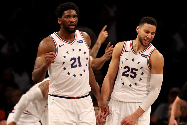 NEW YORK, NEW YORK - APRIL 20:  Joel Embiid #21 and Ben Simmons #25 of the Philadelphia 76ers celebrate the win over the Brooklyn Nets at Barclays Center on April 20, 2019 in the Brooklyn borough of New York City.The Philadelphia 76ers defeated the Brooklyn Nets 112-108. NOTE TO USER: User expressly acknowledges and agrees that, by downloading and or using this photograph, User is consenting to the terms and conditions of the Getty Images License Agreement. (Photo by Elsa/Getty Images)