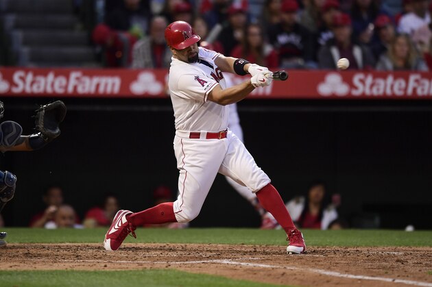 Los Angeles Angels' Albert Pujols hits a an RBI double during the third inning of a baseball game against the Seattle Mariners Saturday, April 20, 2019, in Anaheim, Calif. With that RBI, Pujols tied Babe Ruth for 5th place on the all-time RBI list with 1,992. (AP Photo/Mark J. Terrill)