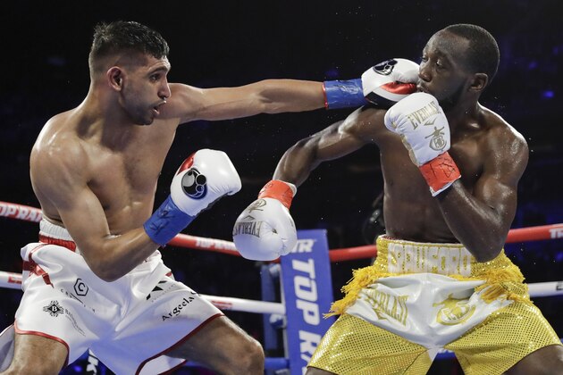 England's Amir Khan, left, punches Terence Crawford during the third round of a WBO world welterweight championship boxing match Sunday, April 21, 2019, in New York. Crawford won the fight. (AP Photo/Frank Franklin II)