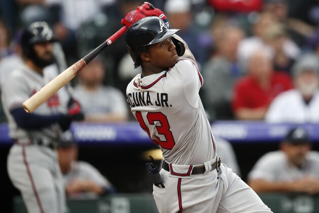 Atlanta Braves' Ronald Acuna Jr. follows the flight of his two-run home run off Colorado Rockies starting pitcher Kyle Freeland in the first inning of a baseball game Monday, April 8, 2019, in Denver. (AP Photo/David Zalubowski)