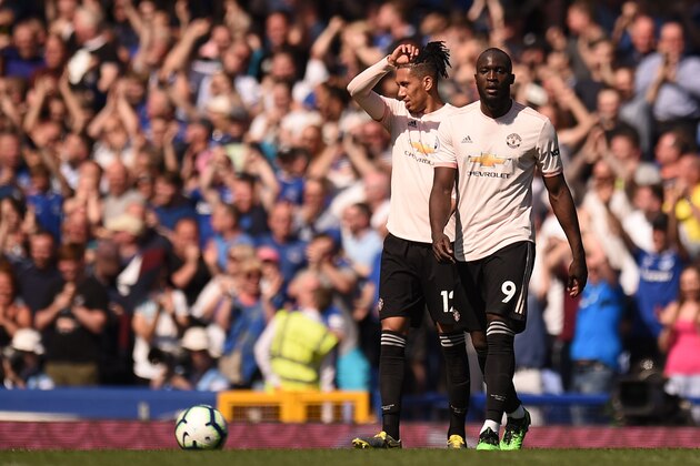 Manchester United's Belgian forward Romelu Lukaku (R) and Manchester United's English defender Chris Smalling (L) react after Everton's third goal during the English Premier League football match between Everton and Manchester United at Goodison Park in Liverpool, north west England on April 21, 2019. (Photo by Oli SCARFF / AFP) / RESTRICTED TO EDITORIAL USE. No use with unauthorized audio, video, data, fixture lists, club/league logos or 'live' services. Online in-match use limited to 120 images. An additional 40 images may be used in extra time. No video emulation. Social media in-match use limited to 120 images. An additional 40 images may be used in extra time. No use in betting publications, games or single club/league/player publications. /         (Photo credit should read OLI SCARFF/AFP/Getty Images)
