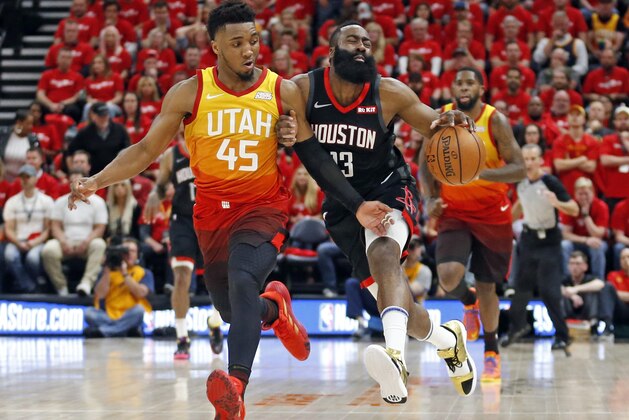 Utah Jazz guard Donovan Mitchell (45) defends against Houston Rockets guard James Harden (13) as he drives up court in the first half during an NBA basketball game Saturday, April 20, 2019, in Salt Lake City. (AP Photo/Rick Bowmer)