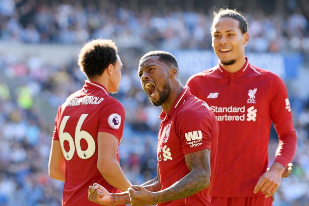 CARDIFF, WALES - APRIL 21:  Georginio Wijnaldum of Liverpool (front) celebrates as he scores his team's first goal during the Premier League match between Cardiff City and Liverpool FC at Cardiff City Stadium on April 21, 2019 in Cardiff, United Kingdom. (Photo by Mike Hewitt/Getty Images)