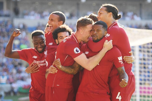 CARDIFF, WALES - APRIL 21:  Georginio Wijnaldum of Liverpool celebrates as he scores his team's first goal with Jordan Henderson and team mates during the Premier League match between Cardiff City and Liverpool FC at Cardiff City Stadium on April 21, 2019 in Cardiff, United Kingdom. (Photo by Mike Hewitt/Getty Images)