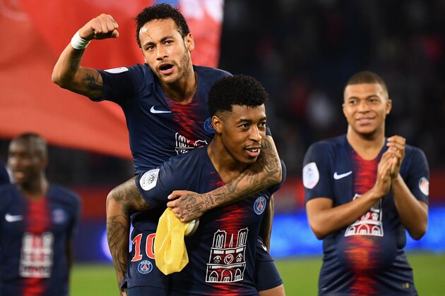 Paris Saint-Germain's Brazilian forward Neymar (Up) celebrates with Paris Saint-Germain's French defender Presnel Kimpembe during the French L1 football match between Paris Saint-Germain (PSG) and Monaco (ASM) on April 21, 2019 at the Parc des Princes stadium in Paris. (Photo by FRANCK FIFE / AFP)        (Photo credit should read FRANCK FIFE/AFP/Getty Images)