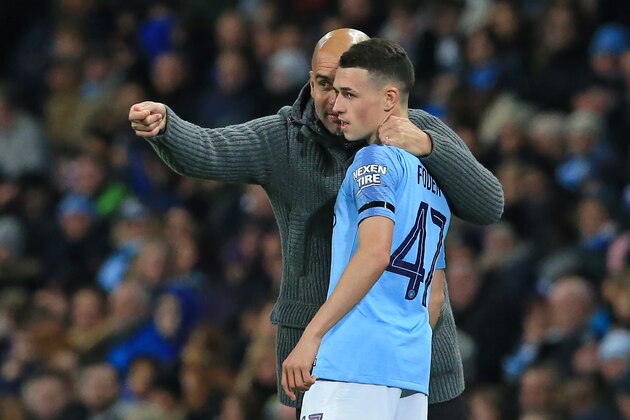 Manchester City's Spanish manager Pep Guardiola (L) speaks with Manchester City's English midfielder Phil Foden (R) during the English League Cup, 4th round football match between Manchester City and Fulham at the Etihad Stadium in Manchester, north west England, on November 1, 2018. (Photo by Lindsey PARNABY / AFP) / RESTRICTED TO EDITORIAL USE. No use with unauthorized audio, video, data, fixture lists, club/league logos or 'live' services. Online in-match use limited to 120 images. An additional 40 images may be used in extra time. No video emulation. Social media in-match use limited to 120 images. An additional 40 images may be used in extra time. No use in betting publications, games or single club/league/player publications. /         (Photo credit should read LINDSEY PARNABY/AFP/Getty Images)